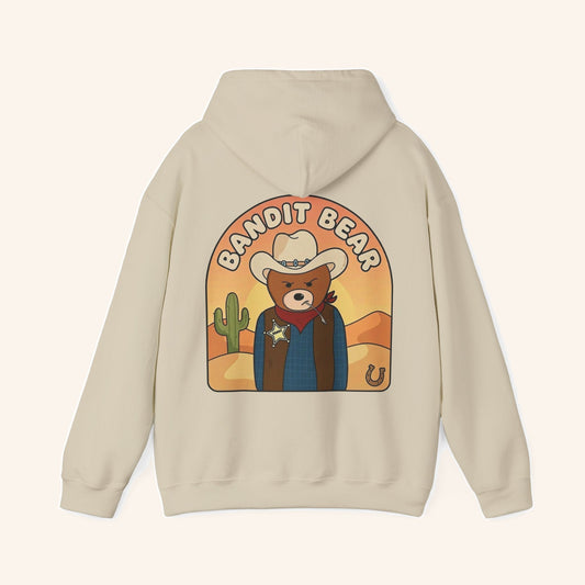 Back of a cream hoodie with a large Bandit Bear cowboy illustration.