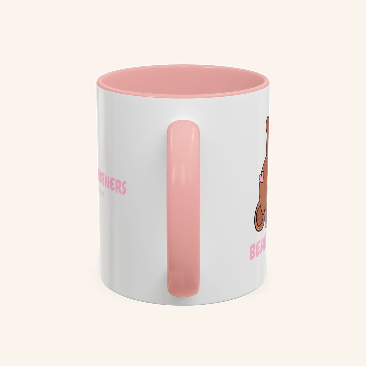 Handle-side view of the pink and white Bear Burners mug.