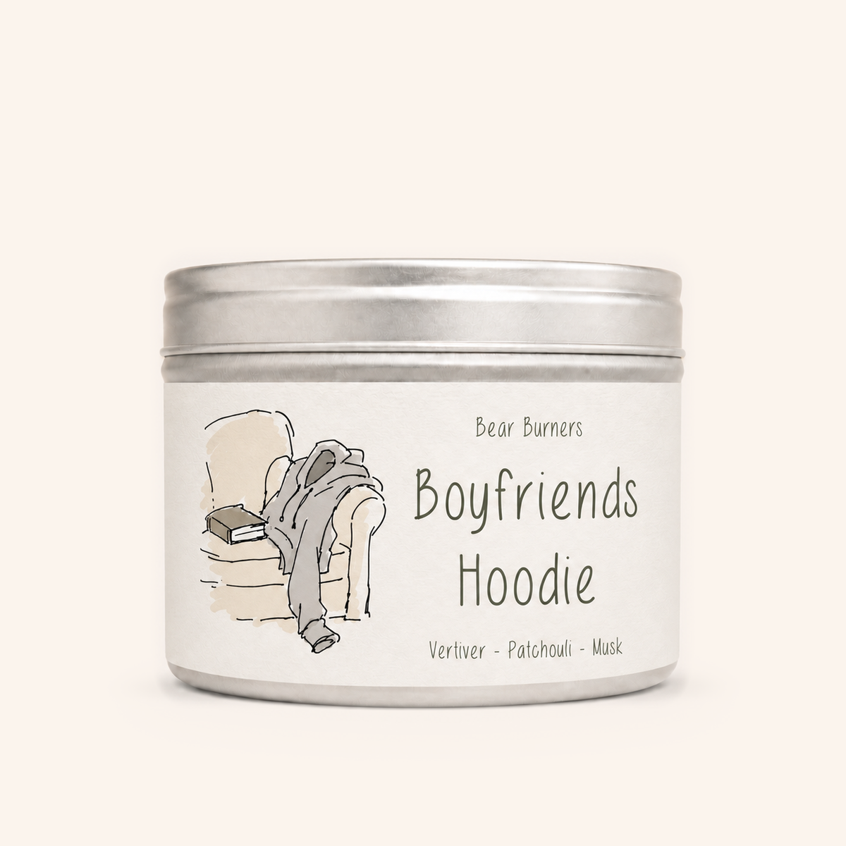 Boyfriend’s Hoodie candle in a silver lidded tin with an illustrated cream label.