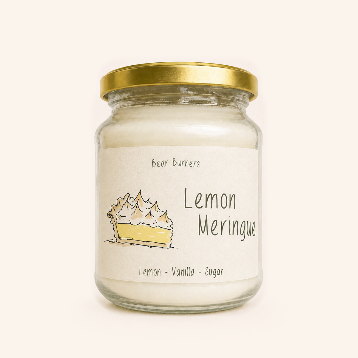 Lemon Meringue candle in a clear glass jar with a gold lid and illustrated cream label.