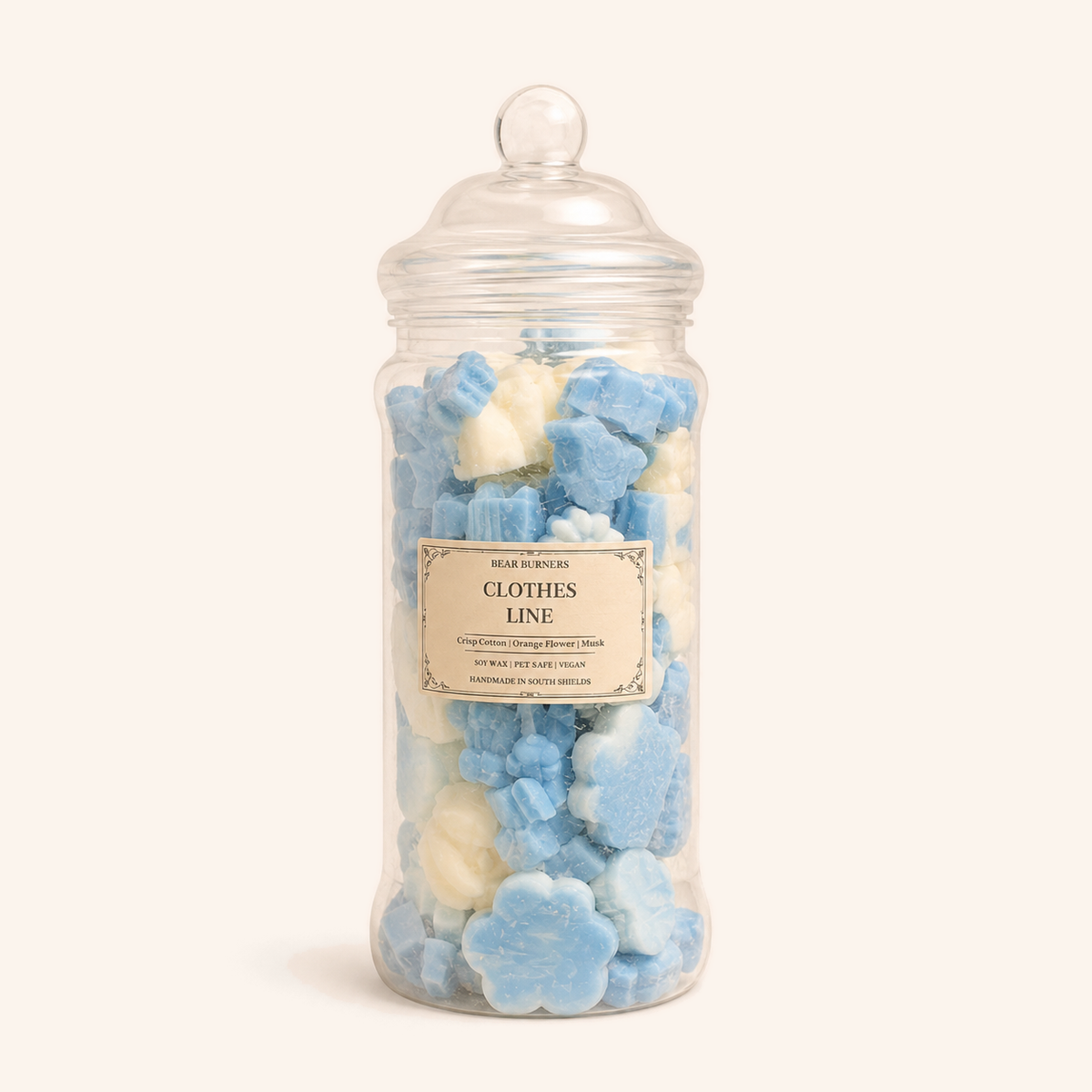 Lidded Pick ’n’ Mix glass jar filled with blue and cream wax pieces.