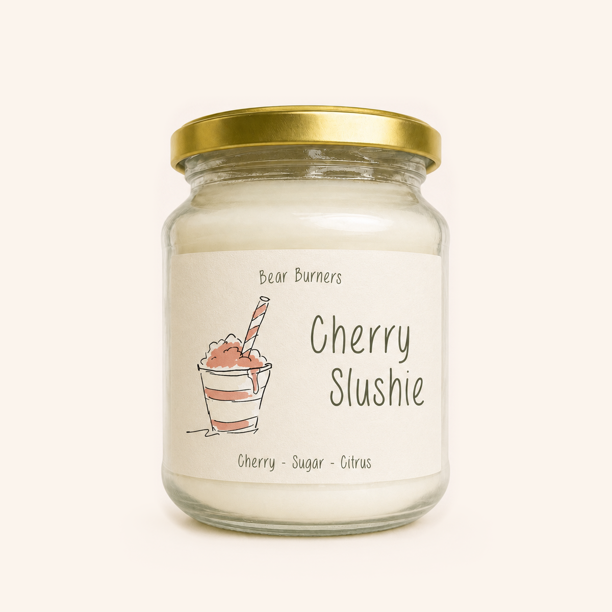 Cherry Slushie candle in a clear glass jar with a gold lid and illustrated cream label.
