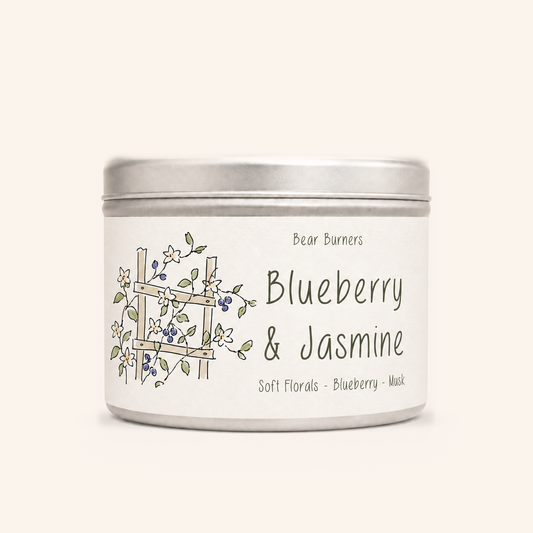 Blueberry & Jasmine candle in a silver lidded tin with an illustrated cream label.