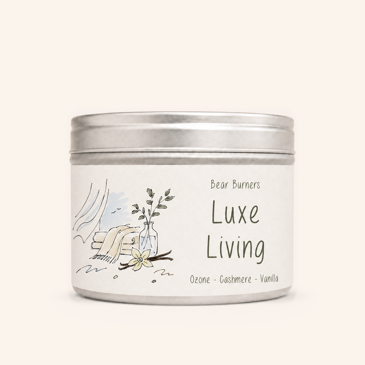 Luxe Living candle in a silver lidded tin with an illustrated cream label.