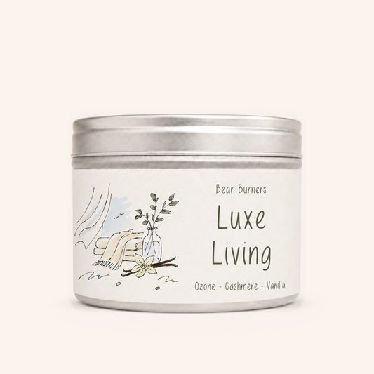 Luxe Living candle in a silver lidded tin with an illustrated cream label.