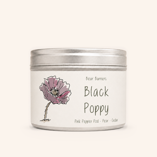 Black Poppy candle in a silver lidded tin with an illustrated cream label.