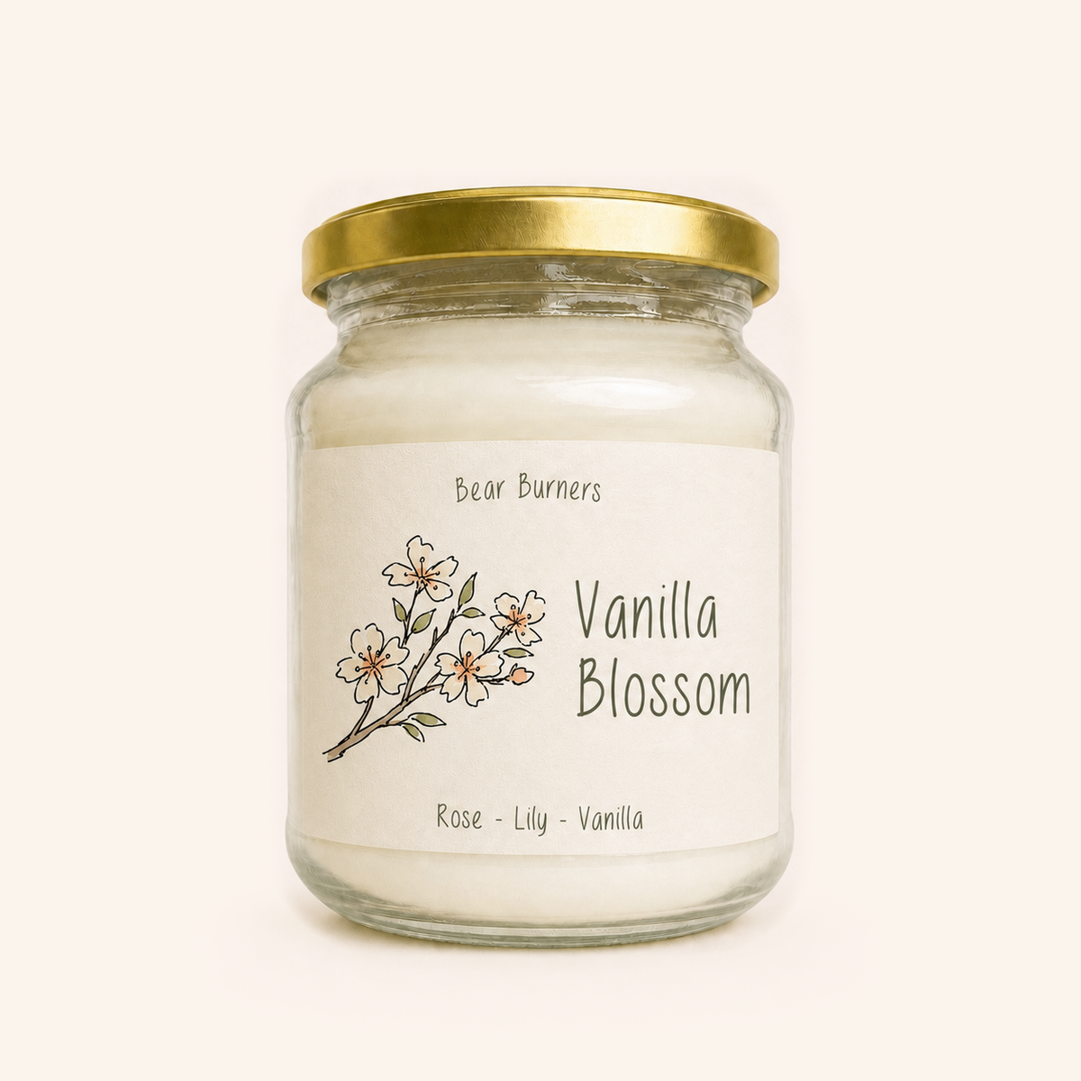 Vanilla Blossom candle in a clear glass jar with a gold lid and illustrated cream label.