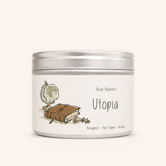 Utopia candle in a silver lidded tin with an illustrated cream label.