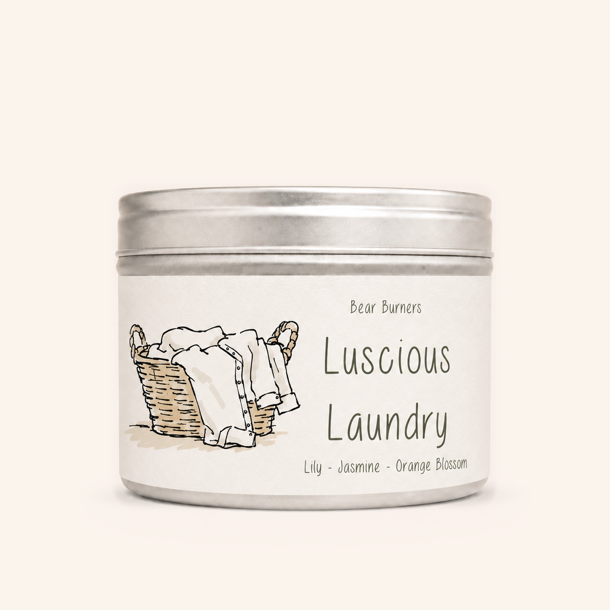 Luscious Laundry candle in a silver lidded tin with an illustrated cream label.