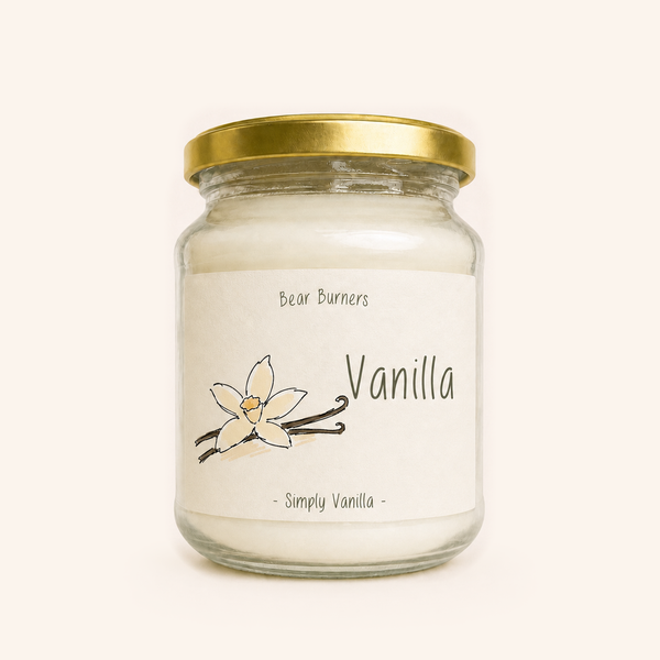 Vanilla candle in a clear glass jar with a gold lid and illustrated cream label.