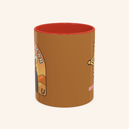 Angled view of the Bandit mug with cowboy artwork and a red interior.