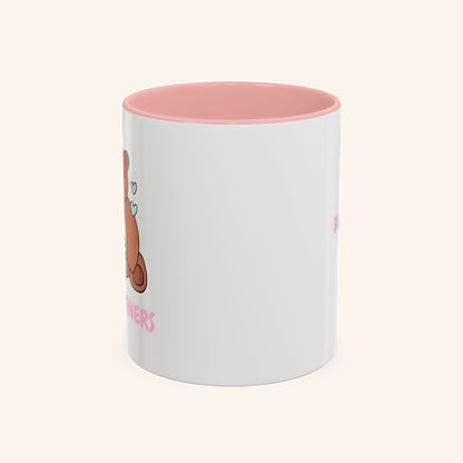 Angled view of the pink-handled Bear Burners mug and bear artwork.