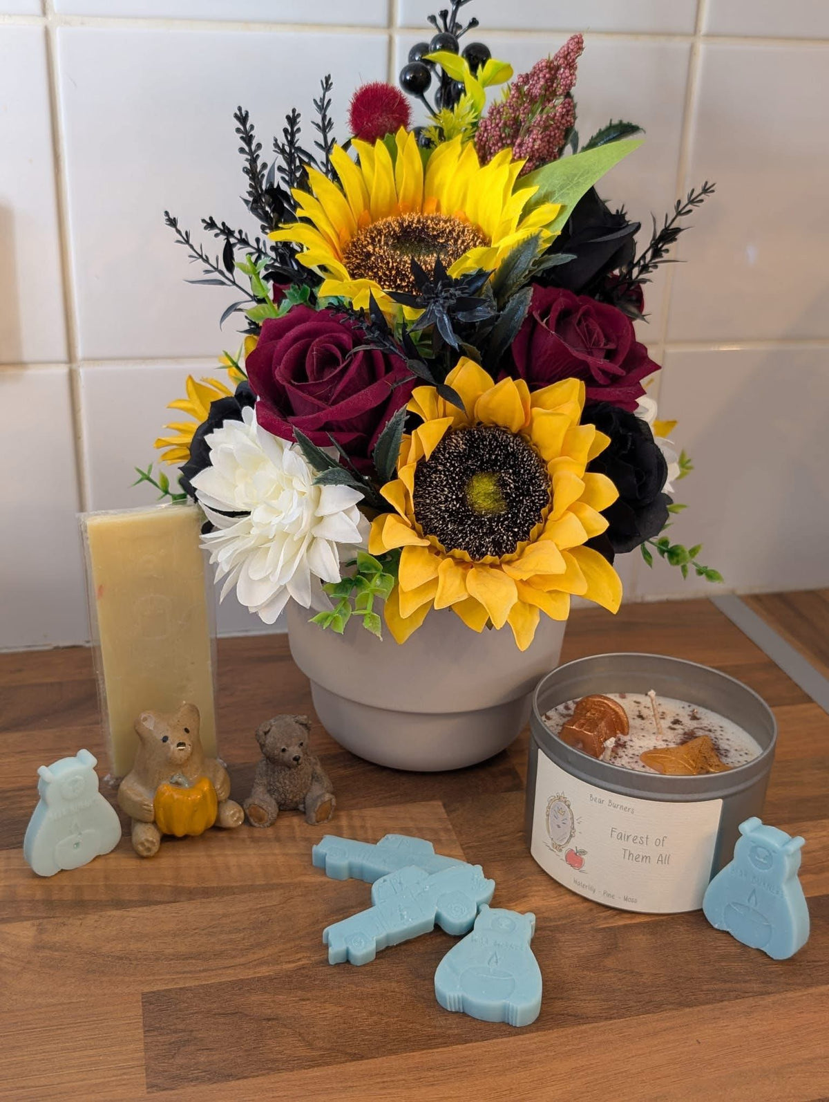 A customer's Candle Club candle and wax melts displayed beside sunflowers