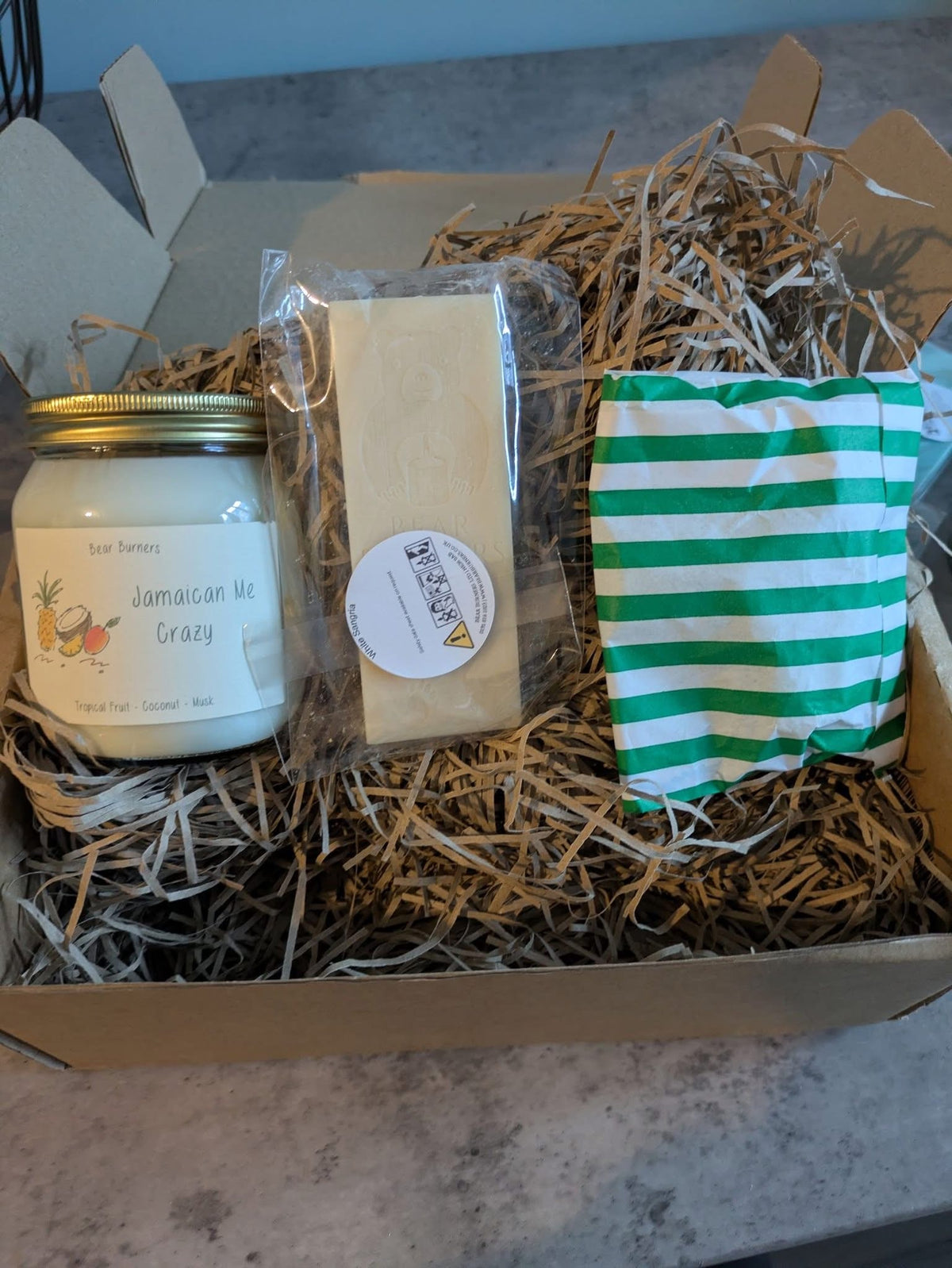 Jamaican Me Crazy candle, snap bar and striped wax melt bag in a Candle Club box