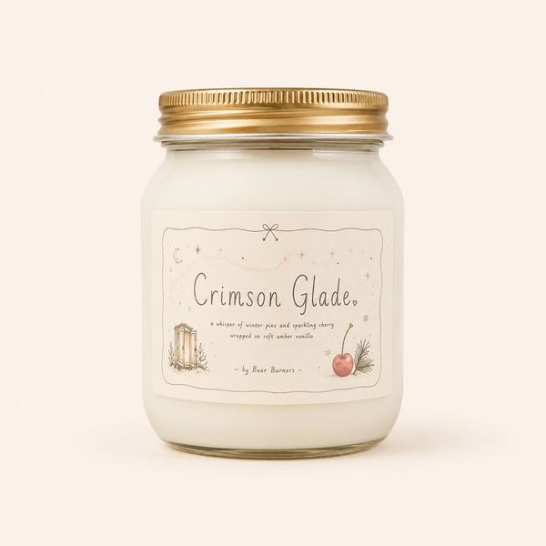 Crimson Glade candle in a clear glass jar with a gold lid and illustrated cream label.