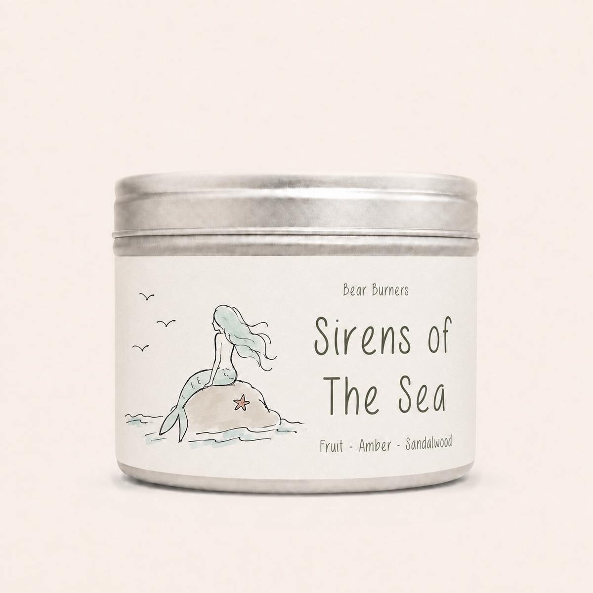 Sirens of the Sea candle in a silver lidded tin with a mermaid label.