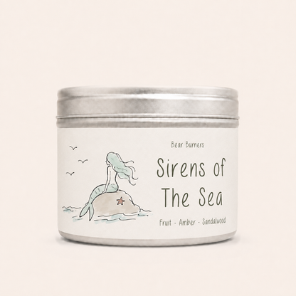 Sirens of the Sea candle in a silver lidded tin with a mermaid label.